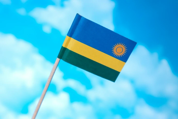 a small flag flying in the wind on a sunny day